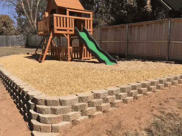 Retaining wall built around playground by Oklahoma City's best landscaping company Freeman's Landscaping